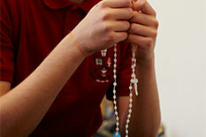 Picture of someone holding a rosary
